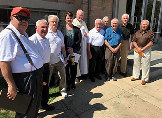 Members of the Class of 1952 at the blessing of the rain gardens at SS. John Neumann and Maria Goretti High School.