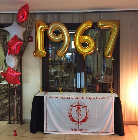 table with St. Maria Goretti HS bannor with 1967 above the table